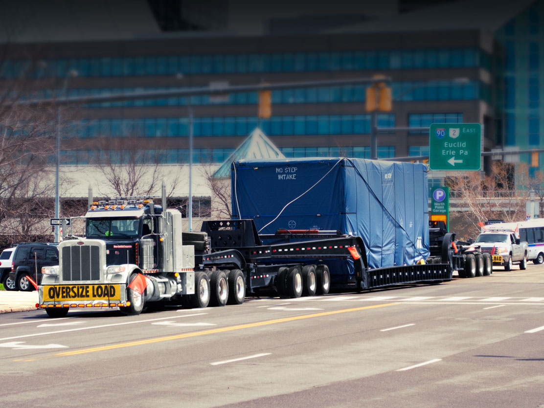 A perimeter 13 axle trailer moving down East 9th Steet in Cleveland, Ohio.