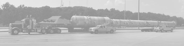 A greyed out version of an oversized load parked inside a rest area flanked by two pilot car vehicles.