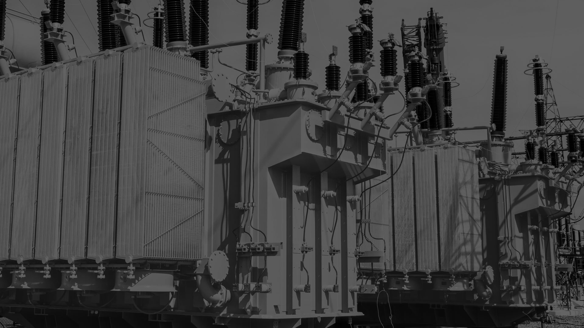 A darkened black and white image of a electrical transformer.