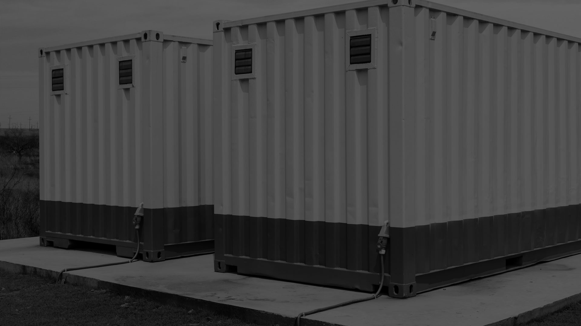 A darkened black and white image of container buildings.