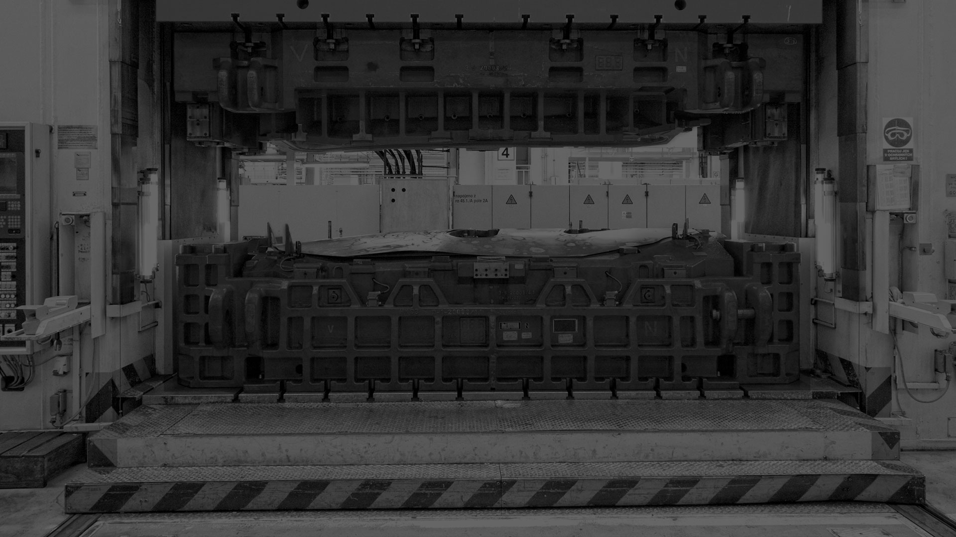 A darkened black and white image of a press system.