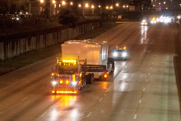 A perimeter 13 axle traveling down the interstate during the night time hours.