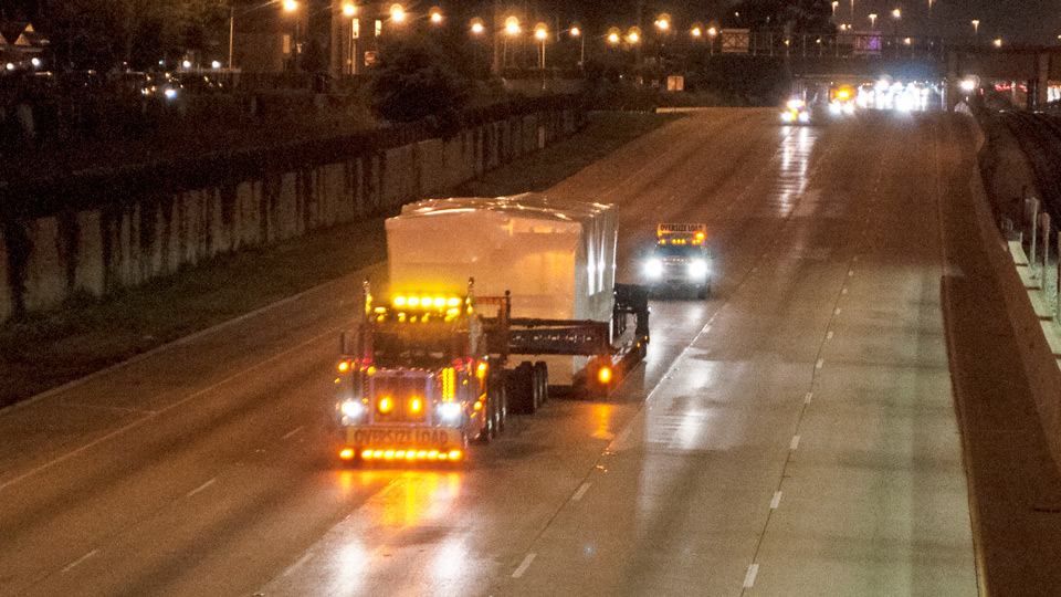 A perimeter 13 axle traveling down the interstate during the night time hours.