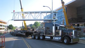 A bridge section being offloaded from a bolster and dolly setup.