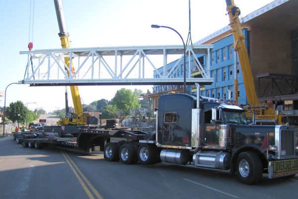 A bridge section being offloaded from a bolster and dolly setup.