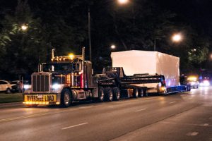 A control building being shipped in the middle of the night in Downtown Chicago.